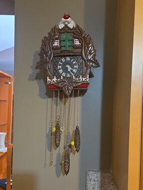 Carved Brown Wall Cuckoo Clock with Green Door and Red Accents